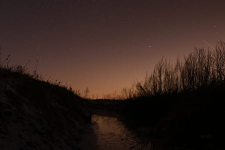 silhouette of hill during night time thumbnail