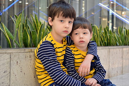 two boys wearing striped sweatshirts thumbnail