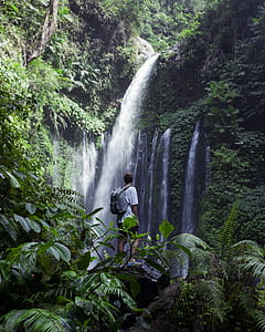 man looking waterfalls during daytime thumbnail