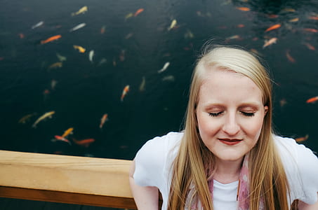 woman standing beside body of water thumbnail