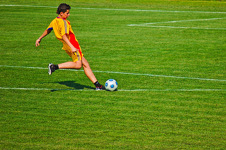 men kicking ball on field thumbnail