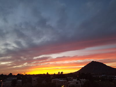 Gray and White Buildings and Brown Mountain during Dusk thumbnail