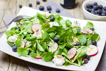 slices of blueberries, dragon fruit and green leafy vegetables thumbnail