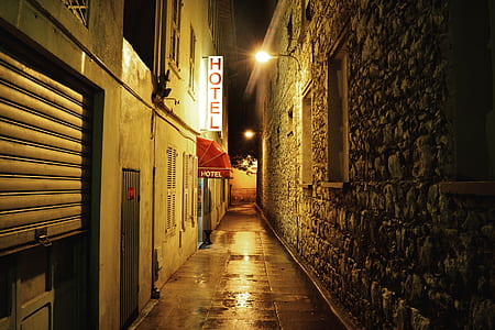 Hotel lighted signboard on brown wall thumbnail