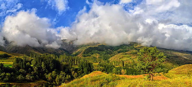 green mountain top under blue sunny cloudy sky thumbnail