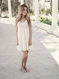 woman standing on side of white pillar thumbnail