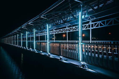 brown concrete bridge with LED lights during nighttime thumbnail