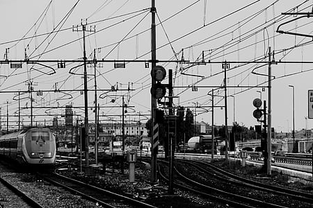 grayscale photo of train on train rails at daytime thumbnail