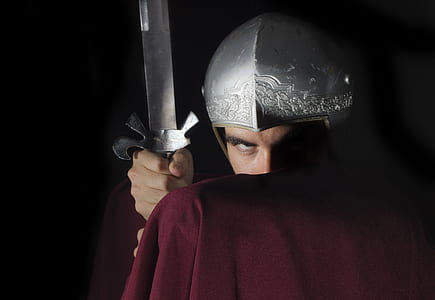 man in red cape and silver helmet holding silver sword thumbnail
