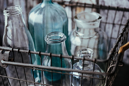 Collection of bottles in metal mesh basket thumbnail