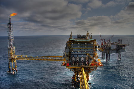oil refinery in the middle of body of water during daytime thumbnail