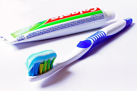Colagate and toothbrush on white surface thumbnail