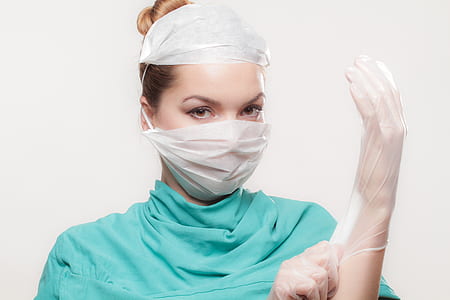 woman wearing teal top and latex gloves thumbnail