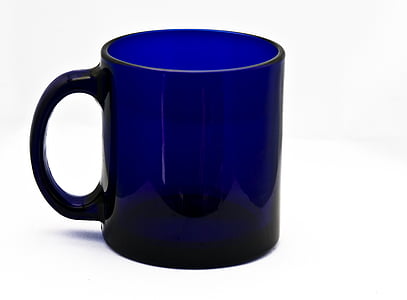 blue and black ceramic mug on white surface thumbnail