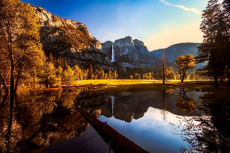 mountain and calm body of water during daytime digital wallpaper thumbnail