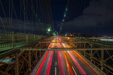 timelapse photography of vehicle on bridge at nighttime thumbnail