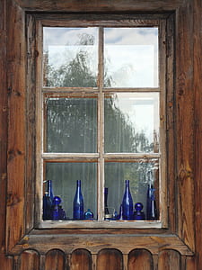blue bottles near glass window thumbnail
