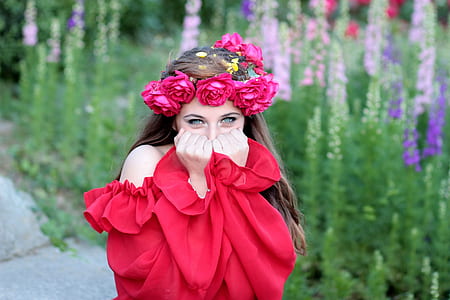 smiling woman covering mouth wearing red off-shoulder blouse thumbnail
