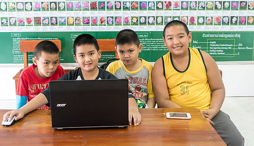 four boys sitting on chair facing table thumbnail