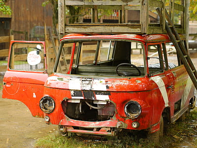 wrecked red van parked near building during daytime thumbnail