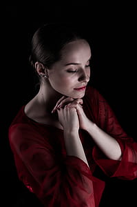 woman closing her eyes while praying thumbnail