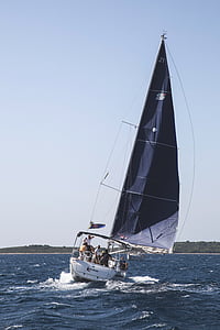 people in white and black sailboat at daytime thumbnail