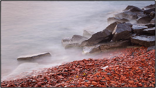 Brown Rock Formation on Body of Water at Daytime thumbnail