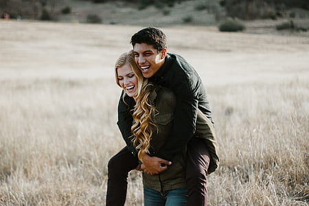 woman in green jacket carrying man thumbnail