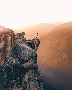 man standing on cliff photo thumbnail