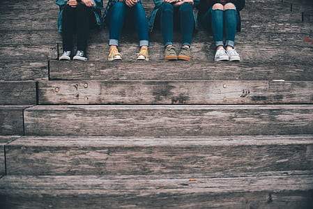 four persons sitting on stair thumbnail