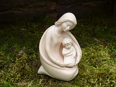 ceramic woman and child figurine on green grass thumbnail