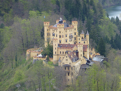 yellow castle near green trees thumbnail