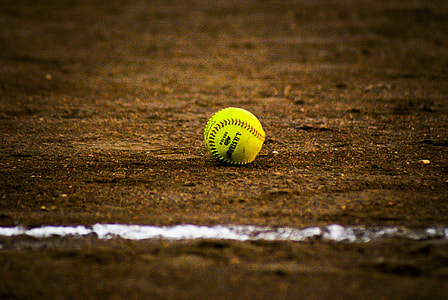 yellow baseball on top of brown soil thumbnail