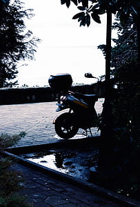 Gray and Yellow Motor Scooter Near Light Post at Daytime thumbnail