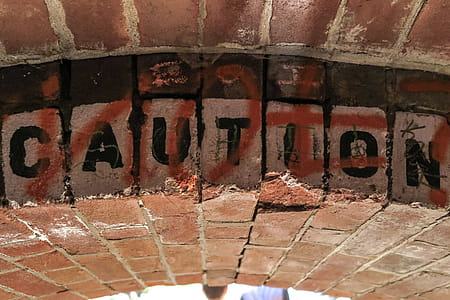 Low brick archway says Caution thumbnail