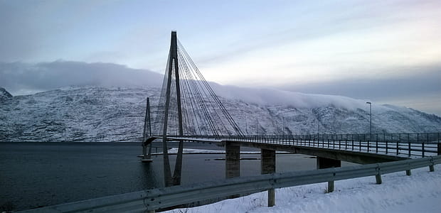 Black Suspension Bridge Under Cumulus Clouds thumbnail