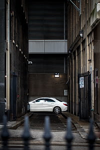 white sedan between buildings thumbnail