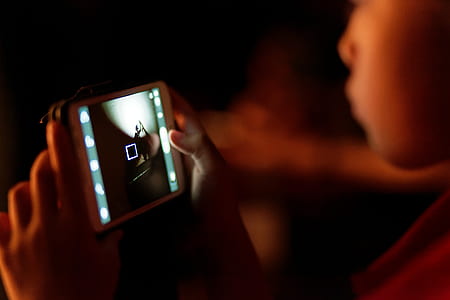 person holding phone displaying camera thumbnail