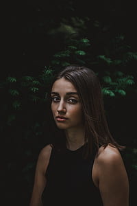 woman in black top on near green leaves on vignette photography thumbnail