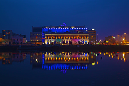 lighted building near body of water during nighttime thumbnail