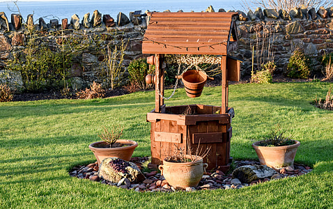 brown wooden deep well with clay pots during daytime thumbnail