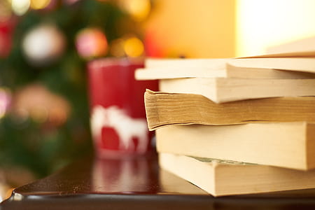 book lot on brown wooden surface in close-up photo thumbnail