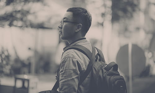 Grayscale Photo of Man Wearing Backpack thumbnail