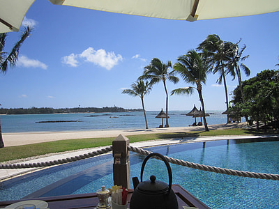 body of water near green palm trees thumbnail