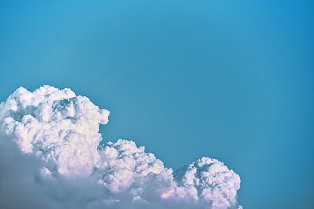 white clouds under teal sky thumbnail