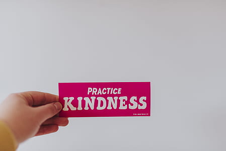 person holding practice kindness signage thumbnail