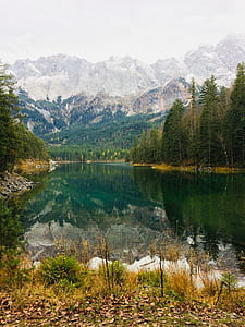 snow covered mountain beside river during daytime thumbnail