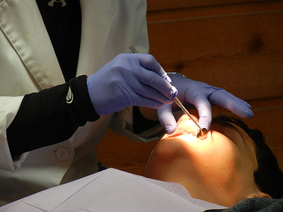person holding gray dental tool thumbnail