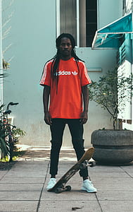 man stepping brown skateboard thumbnail