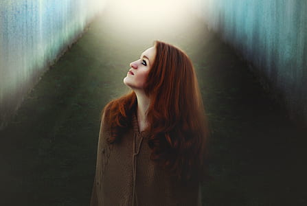 woman facing upward wearing gray jacket thumbnail